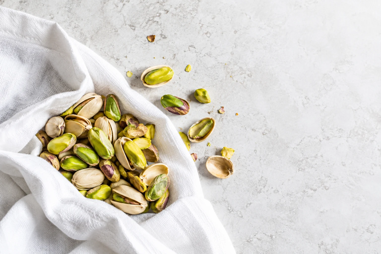Pistachios on white linen